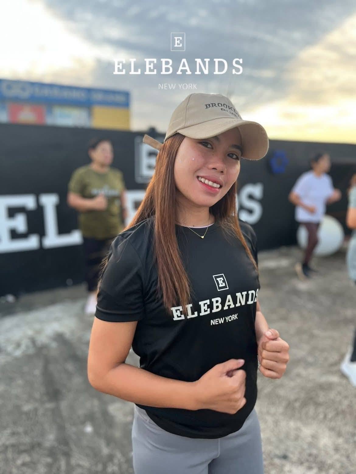 Woman wearing EleBands activewear at an outdoor fitness event