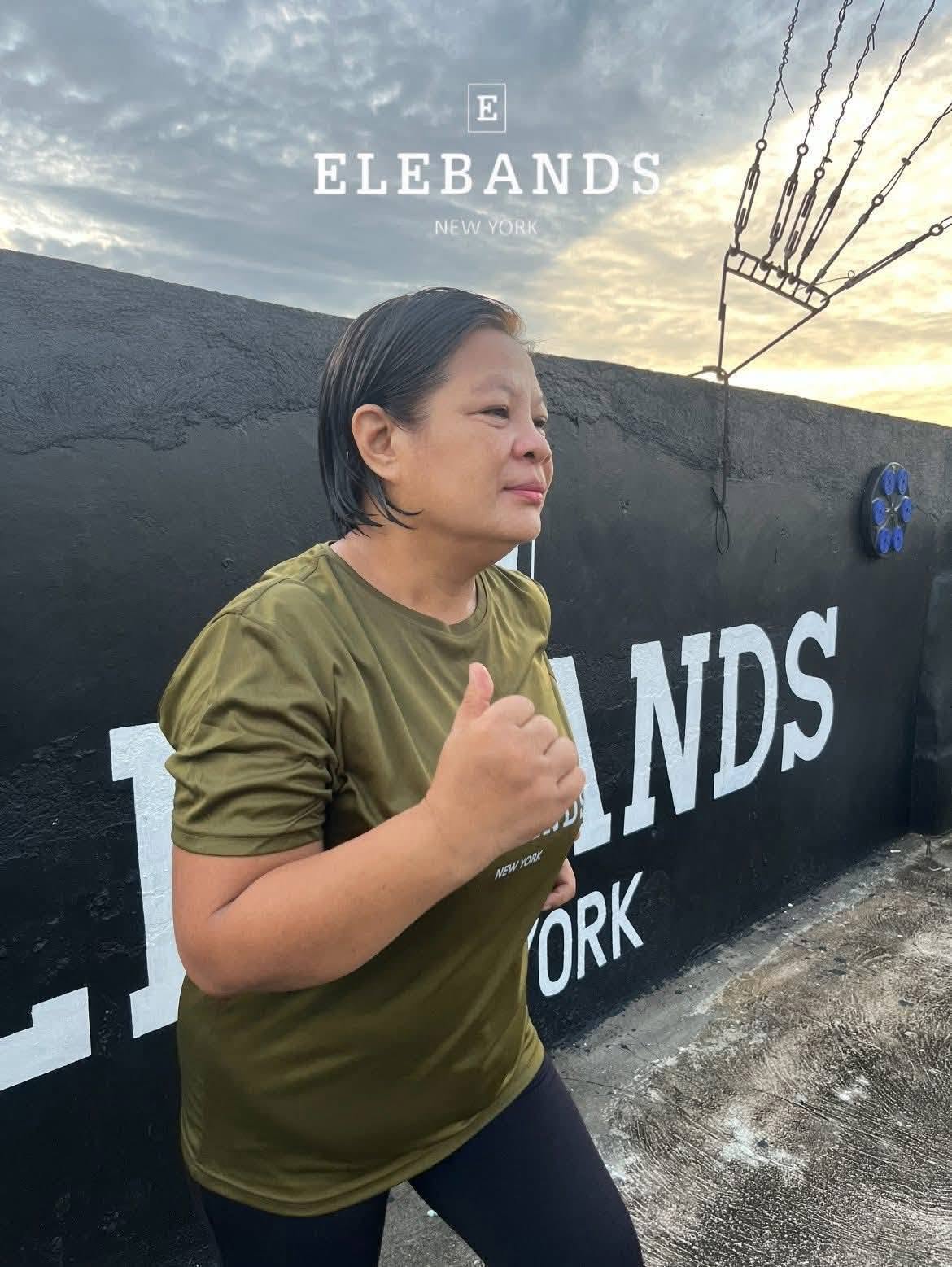 Woman exercising beside an EleBands event display