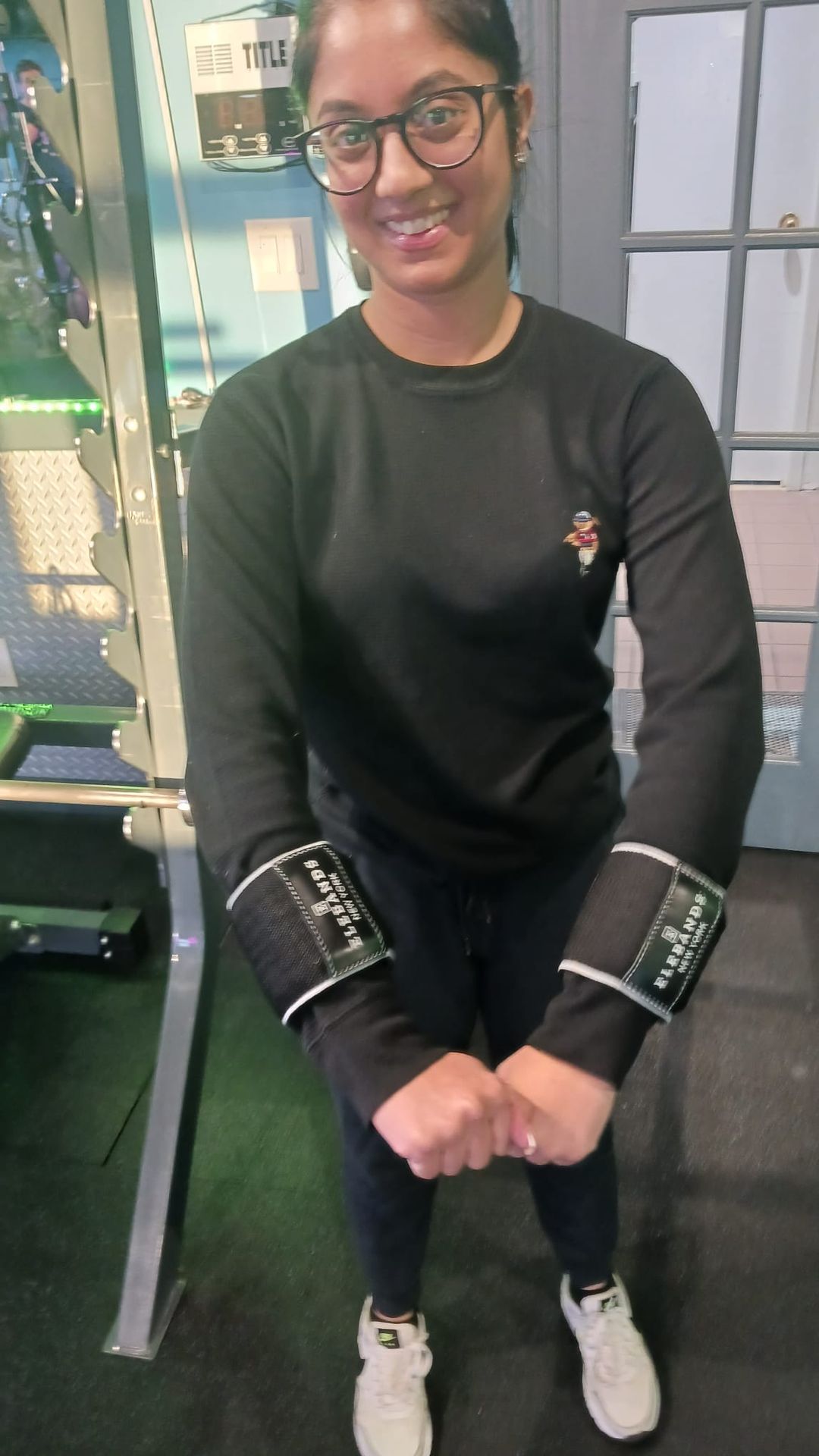 Woman wearing EleBands wrist weights at a fitness center