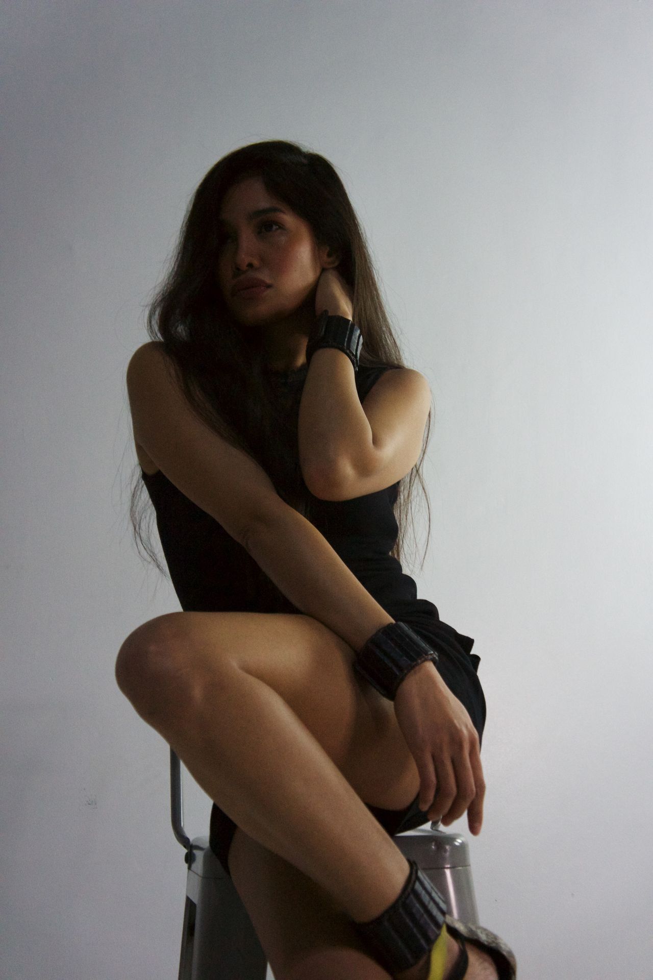 Woman wearing EleBands wrist weights in a studio portrait