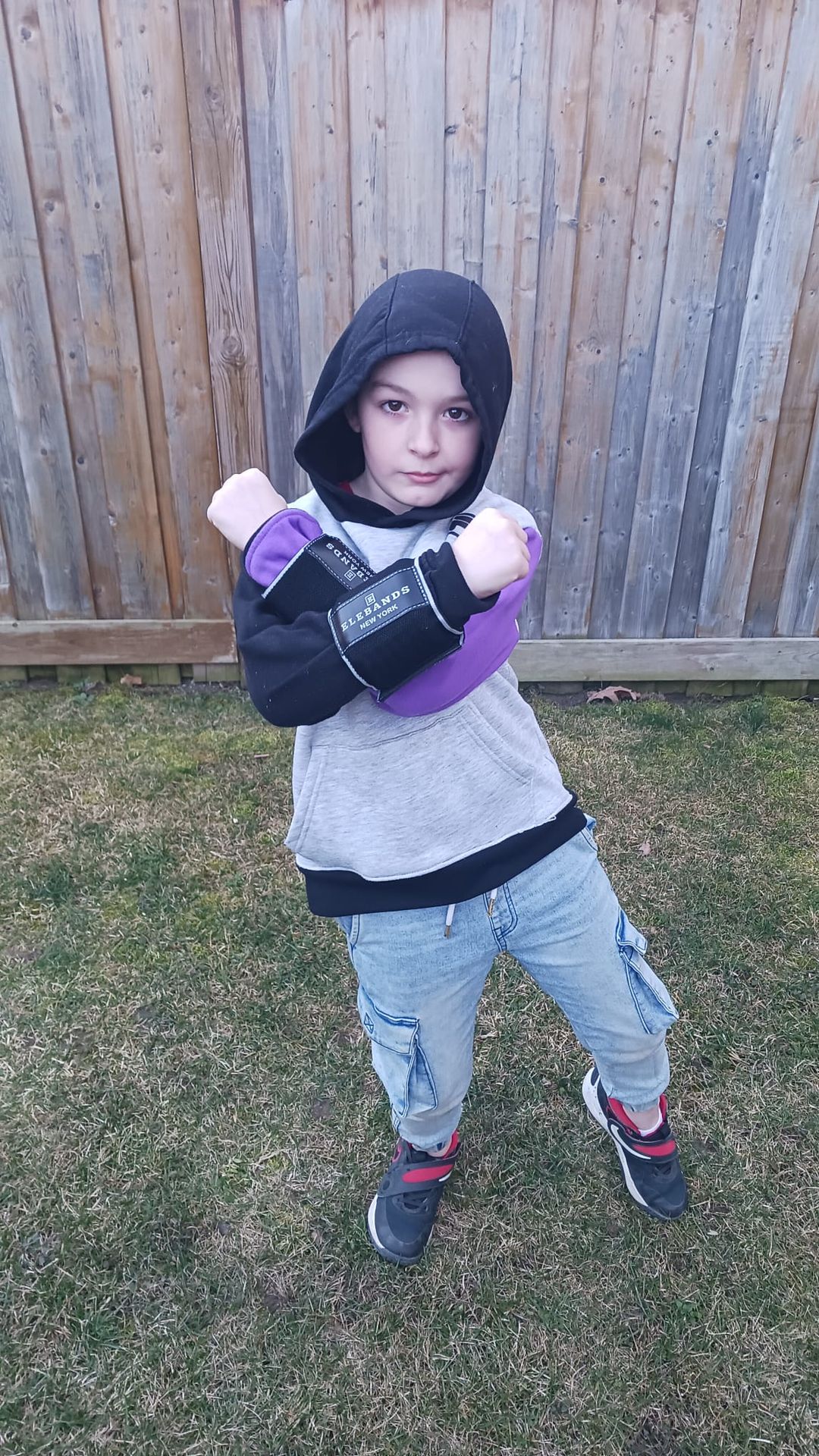 Young child wearing EleBands wrist weights outdoors