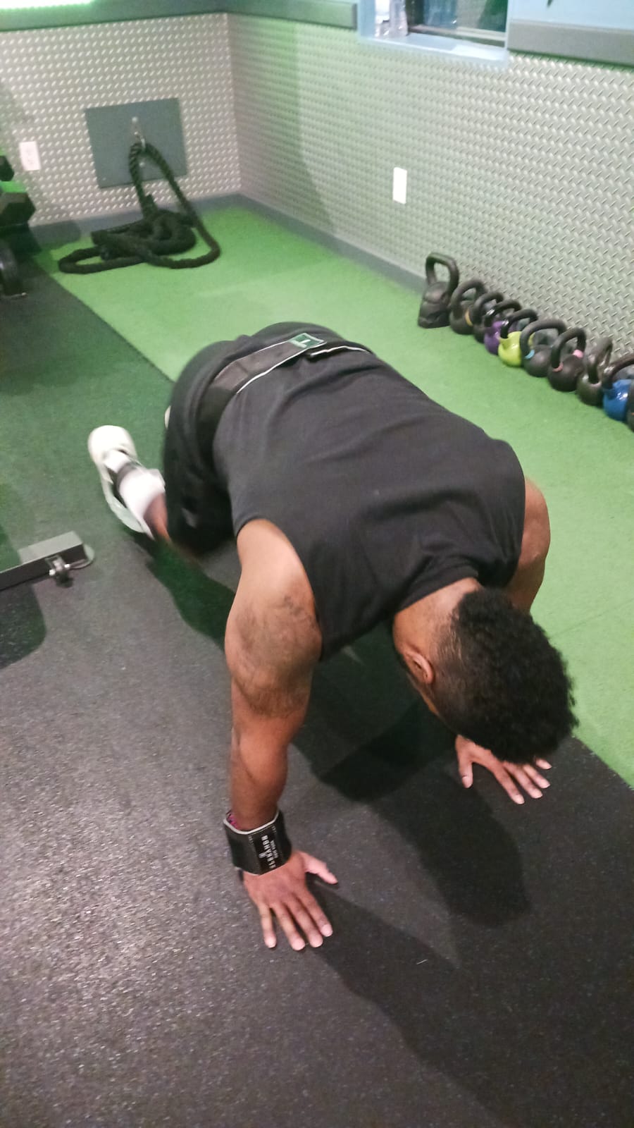 Man doing a floor workout with EleBands wrist weights